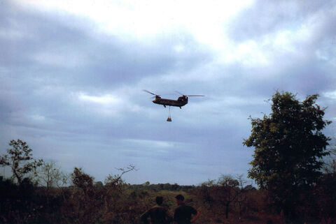 U.S. Army CH-47A Chinook delivering barbed wire for the construction of the minefield fence north of Xa Phuoc Loi 3.1967
