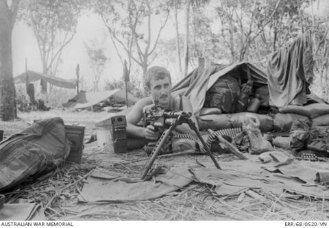 BIEN HOA PROVINCE, SOUTH VIETNAM. 1968-05. BOMBARDIER LARRY DAVENPORT OF VICTOR HARBOR, SA, WAITS AND WATCHES BEHIND HIS M60 MACHINE GUN DURING OPERATION TOAN THANG AT FIRE SUPPORT BASE (FSB) CORAL. A MEMBER OF 12TH FIELD ARTILLERY REGIMENT, ROYAL AUSTRALIAN ARTILLERY (RAA), BOMBARDIER DAVENPORT WAS PART OF THE AUSTRALIAN FORCE DEFENDING FSB CORAL WHEN THE ENEMY TWICE TRIED TO OVER RUN THE AREA ON 1968-05-13 AND 1968-05-16.