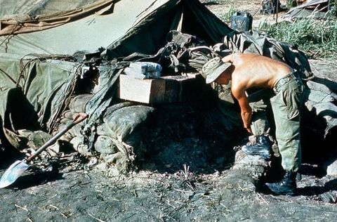 Sergeant Richard Creek of 102 Field Battery inspects the damage inflicted on the Battery’s Command Post by North Vietnamese mortars during an attack in the early hours of 13 May 1968.