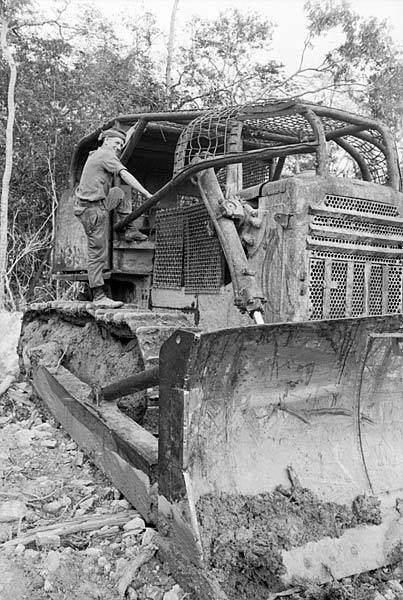 Sapper Ken Lowdon of Vic climbs onto his bulldozer to begin a shift during the land clearing team\\'s Operation Lyrebird in Phuoc Tuy Province. Members of the 1st Field Squadron and the 17th Construction Squadron, Royal Australian Engineers (RAE), were involved in the operation to clear trails through 30 kilometres of thickly jungled foothills of the Nui Dinh, Nui Thi and Nui Thi Vai hills, a few kilometres west of the 1st Australian Task Force Base at Nui Dat, 1968.