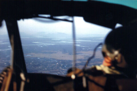 Looking forward, south-west Phuoc Tuy Province from R.A.A.F. UH-1B Iroquois as B Company 5 R.A.R. travel towards Route 15 20.12.66