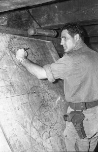 The Battery commander of the 4RAR/NZ Direct Support Field Battery plots patrol locations on his battle map at the Fire Support Control Centre in the battalion command post. Photo courtesy of Derrill de Heer.